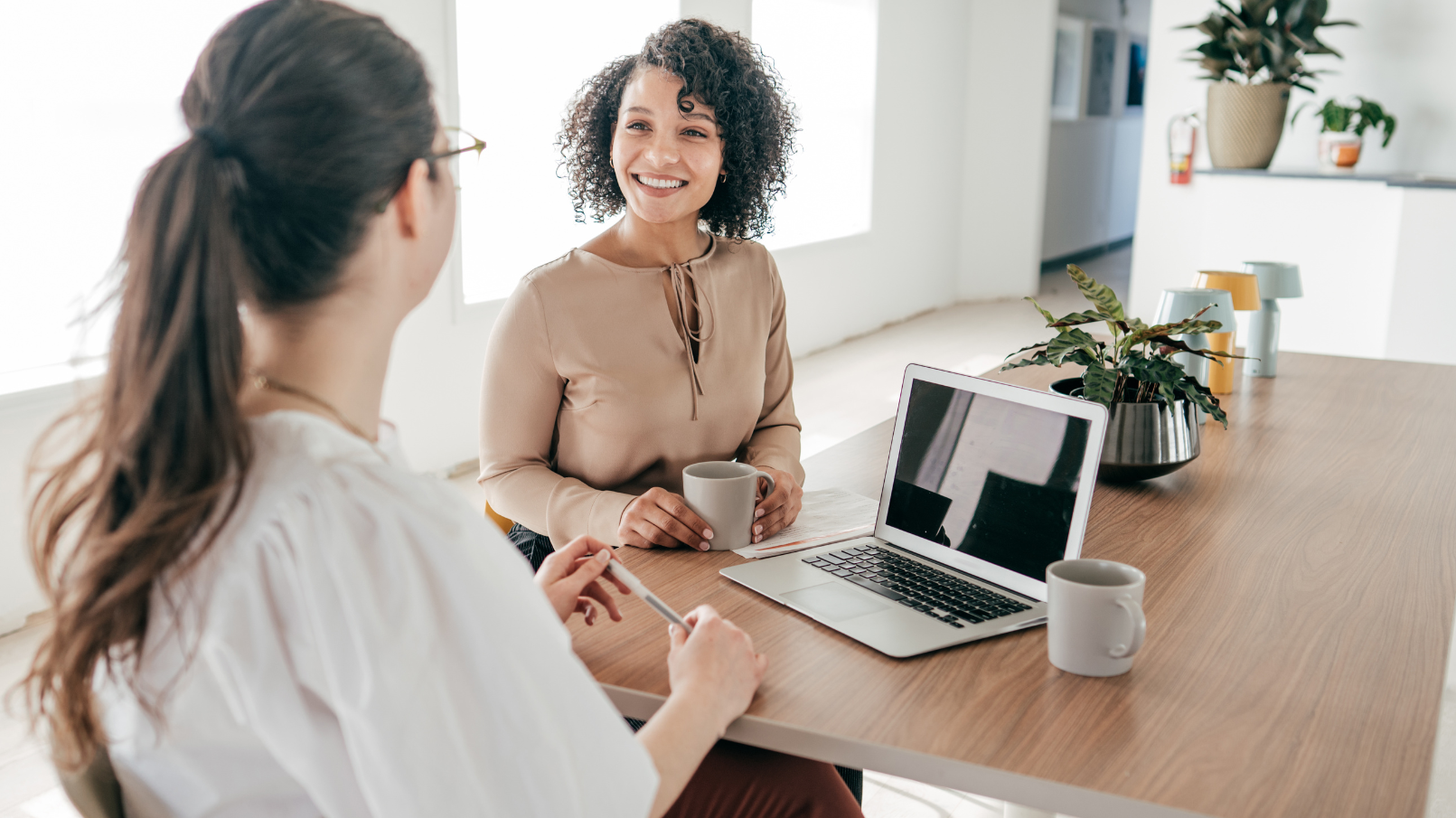 hr-manager-and-employee-at-desk-talking