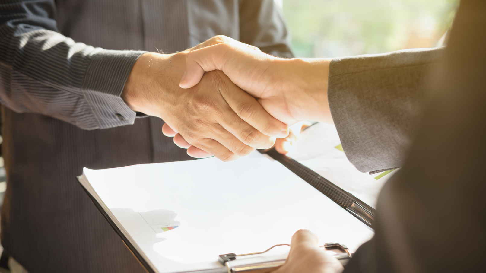 people-shaking-hands-over-a-contract