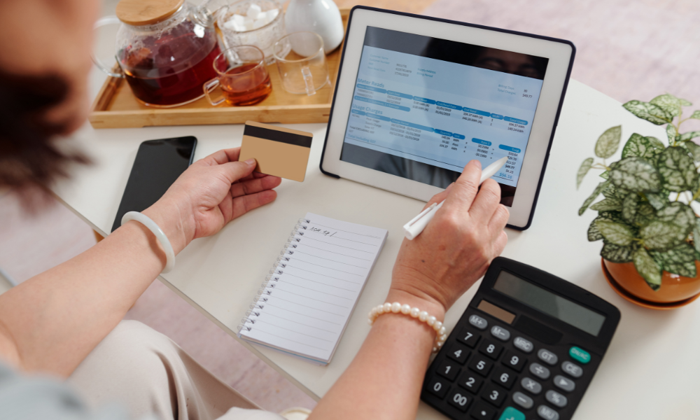 woman-reviewing-utility-invoices-with-calculator